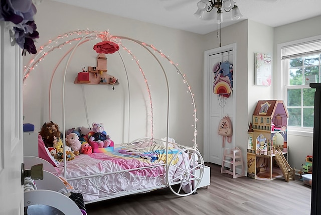 bedroom with ceiling fan and hardwood / wood-style flooring