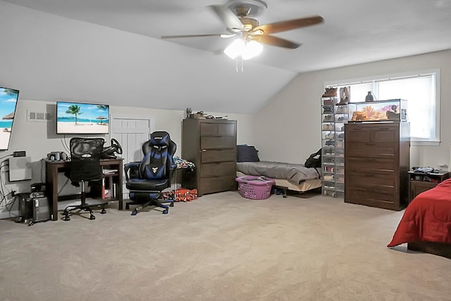 carpeted home office featuring lofted ceiling and ceiling fan