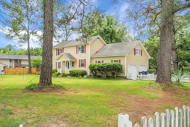 view of front of house featuring a garage and a front lawn