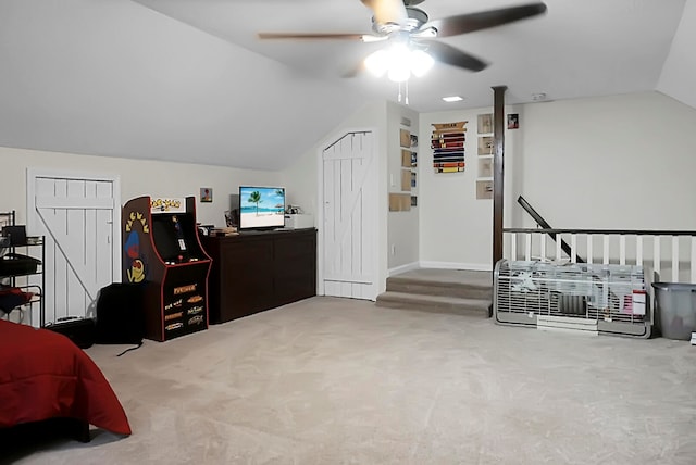 carpeted home office with vaulted ceiling and ceiling fan