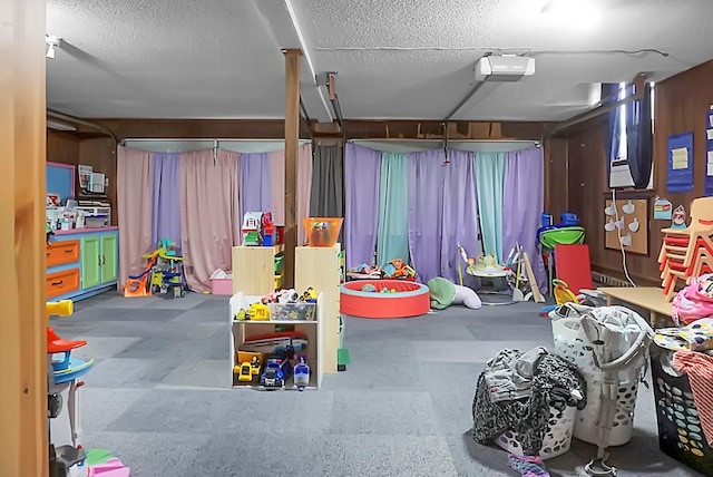 game room with a textured ceiling