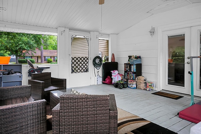 sunroom / solarium featuring lofted ceiling