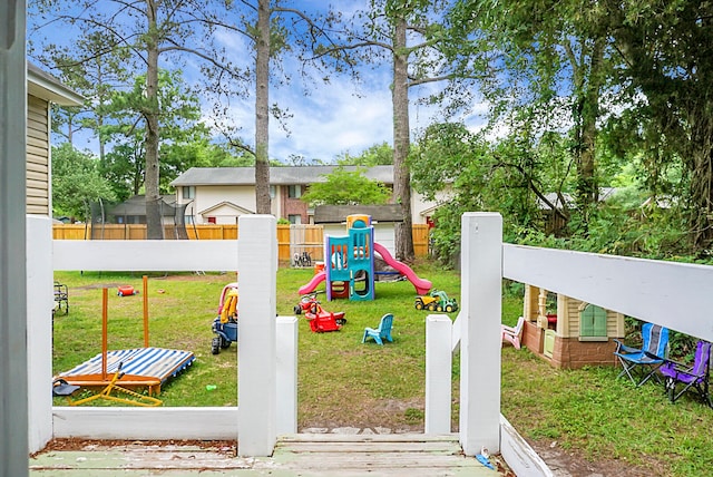 view of play area featuring a trampoline and a yard