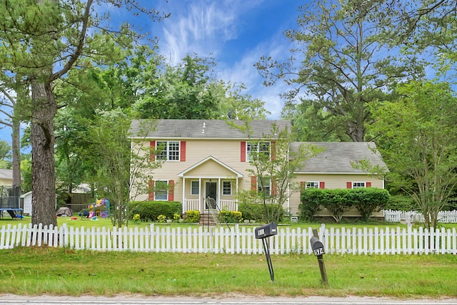 colonial-style house with a front lawn