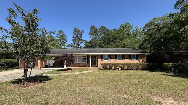 single story home featuring a carport, concrete driveway, brick siding, and a front lawn