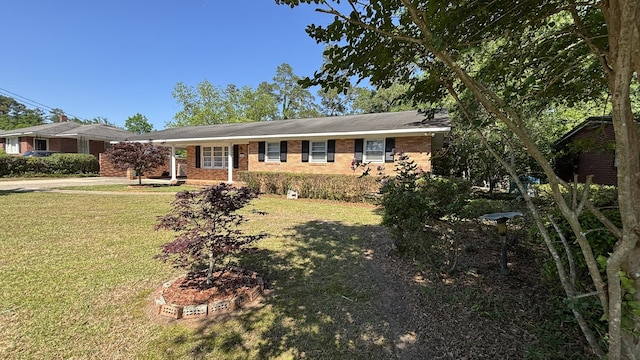 ranch-style house with brick siding, a front yard, and driveway