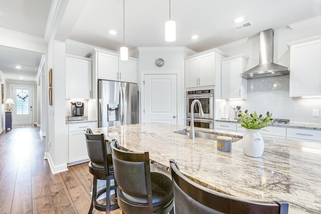 kitchen with dark wood-style floors, visible vents, stainless steel appliances, crown molding, and wall chimney exhaust hood