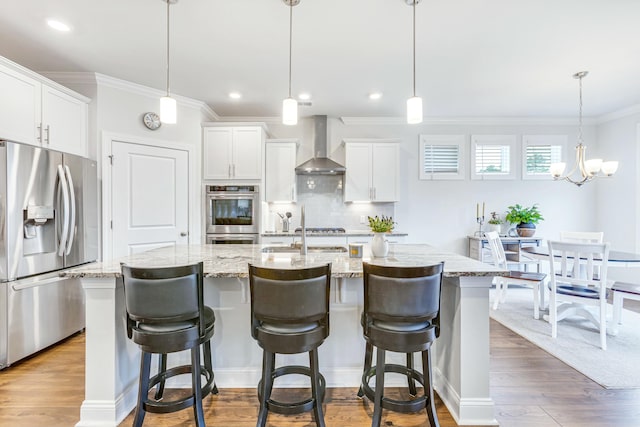 kitchen featuring backsplash, appliances with stainless steel finishes, wall chimney exhaust hood, and dark wood-style flooring