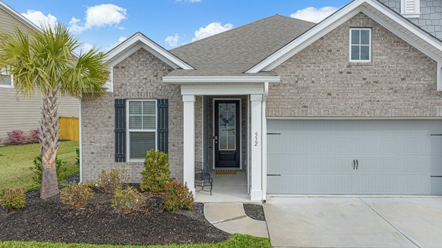 view of front of home with driveway and roof with shingles