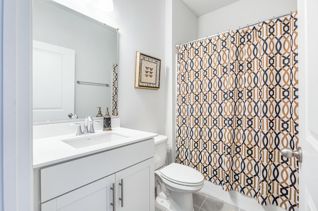 bathroom with tile patterned flooring, curtained shower, toilet, and vanity