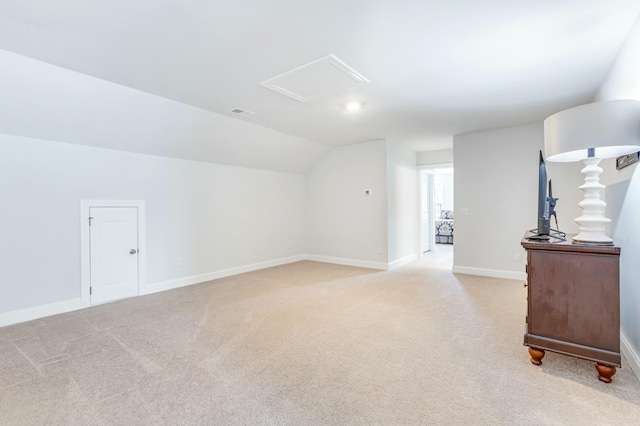 bonus room featuring visible vents, light colored carpet, baseboards, and lofted ceiling