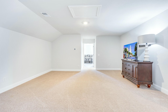 bonus room featuring lofted ceiling, visible vents, baseboards, and light carpet