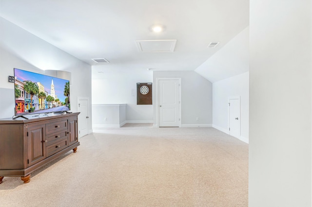 additional living space with light carpet, visible vents, baseboards, and vaulted ceiling