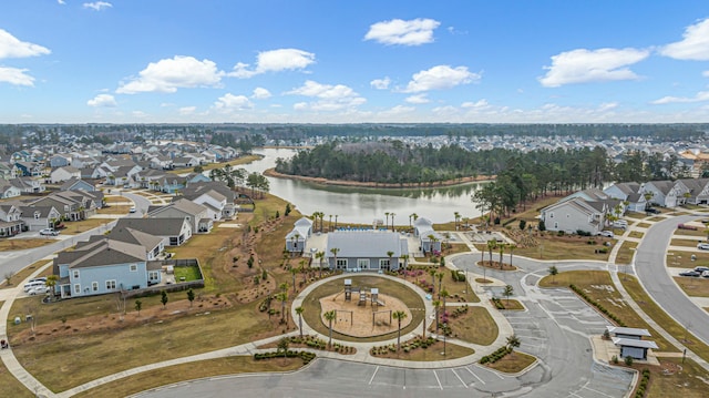 drone / aerial view with a water view and a residential view