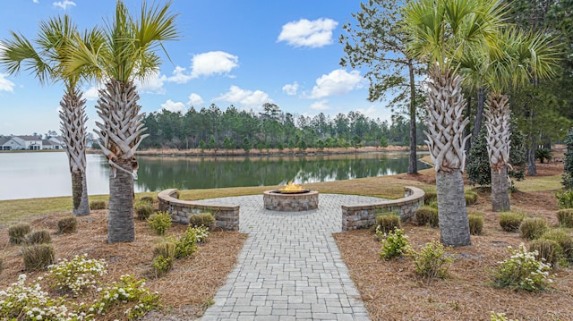 view of yard featuring a fire pit and a water view