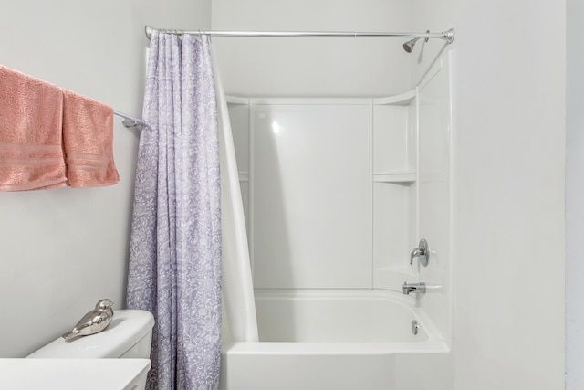 full bathroom featuring vanity, shower / bath combination with curtain, and toilet