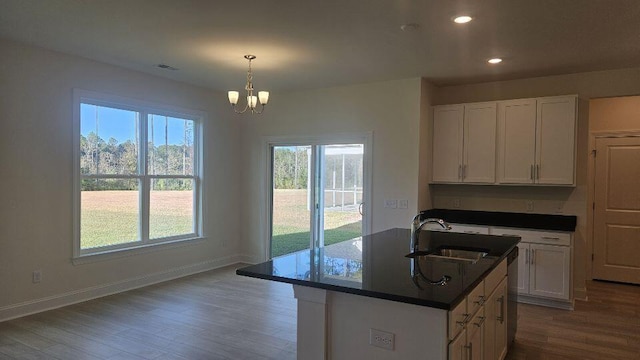 259 Huguenot Trl, Huger, SC 29450 - kitchen featuring dark countertops, wood finished floors, a chandelier, recessed lighting, and white cabinetry