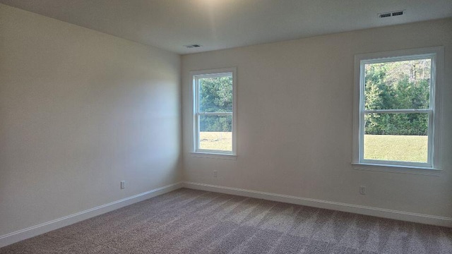 259 Huguenot Trl, Huger, SC 29450 - spare room featuring carpet flooring and baseboards