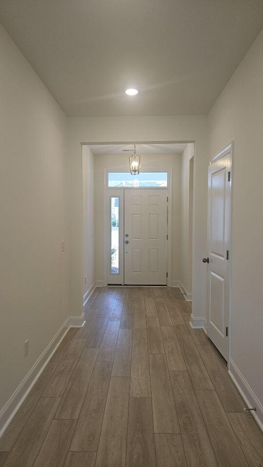 259 Huguenot Trl, Huger, SC 29450 - entryway with wood finished floors, a chandelier, and recessed lighting