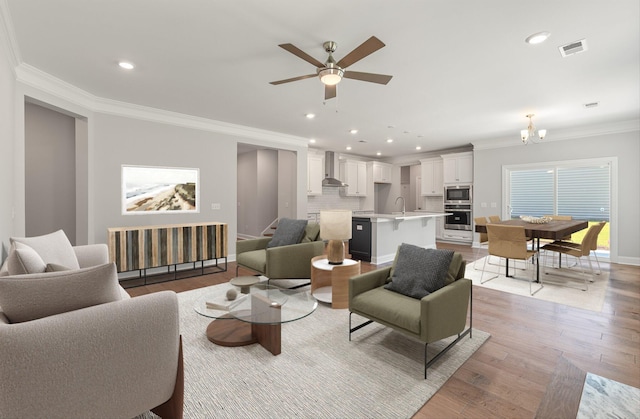 259 Huguenot Trl, Huger, SC 29450 - living room featuring ornamental molding, light wood-style floors, a ceiling fan, a chandelier, and recessed lighting