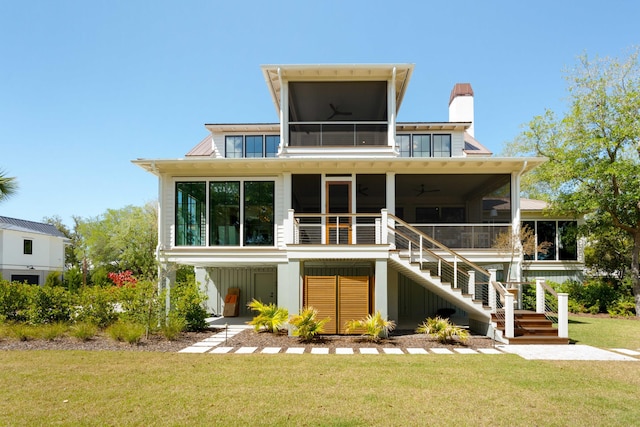 2538 Helmsman Rd, Johns Island, SC 29455 - back of property featuring a ceiling fan, a sunroom, a chimney, a yard, and stairs