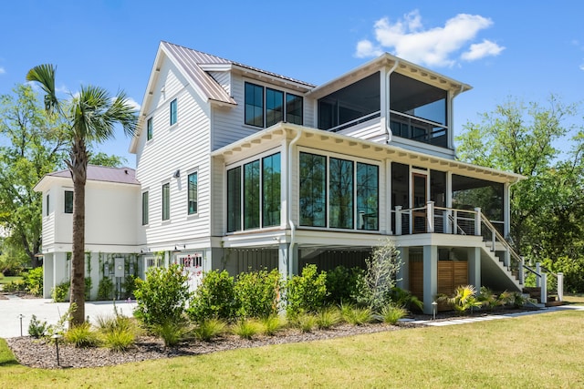 2538 Helmsman Rd, Johns Island, SC 29455 - rear view of property featuring stairs, a balcony, metal roof, a lawn, and a sunroom