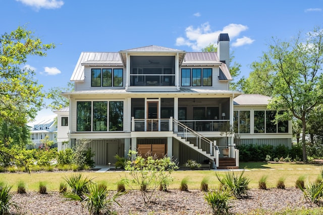 2538 Helmsman Rd, Johns Island, SC 29455 - rear view of house featuring stairway, metal roof, a chimney, a sunroom, and a standing seam roof