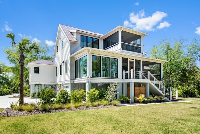 2538 Helmsman Rd, Johns Island, SC 29455 - rear view of house featuring a sunroom, metal roof, a yard, a standing seam roof, and stairs