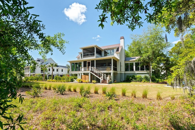 2538 Helmsman Rd, Johns Island, SC 29455 - rear view of house featuring a yard, metal roof, stairway, a chimney, and a sunroom