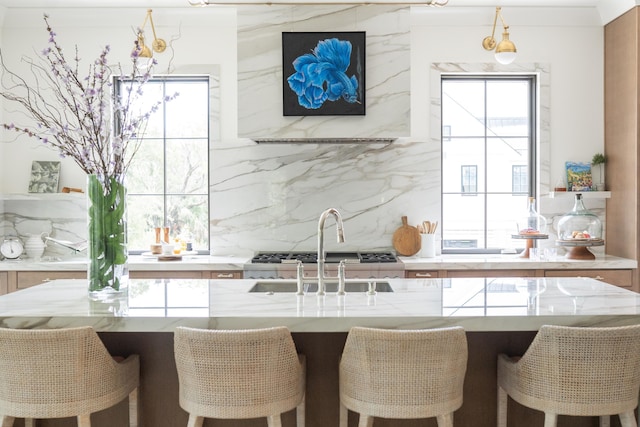 2538 Helmsman Rd, Johns Island, SC 29455 - kitchen with a breakfast bar area, decorative backsplash, a healthy amount of sunlight, and a sink