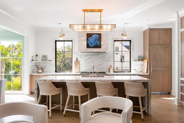 2538 Helmsman Rd, Johns Island, SC 29455 - kitchen with tasteful backsplash, a healthy amount of sunlight, and a center island with sink