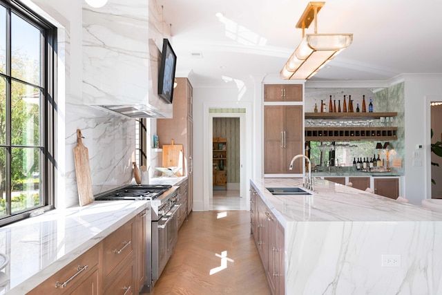 2538 Helmsman Rd, Johns Island, SC 29455 - kitchen with a sink, brown cabinetry, light stone counters, and stainless steel stove