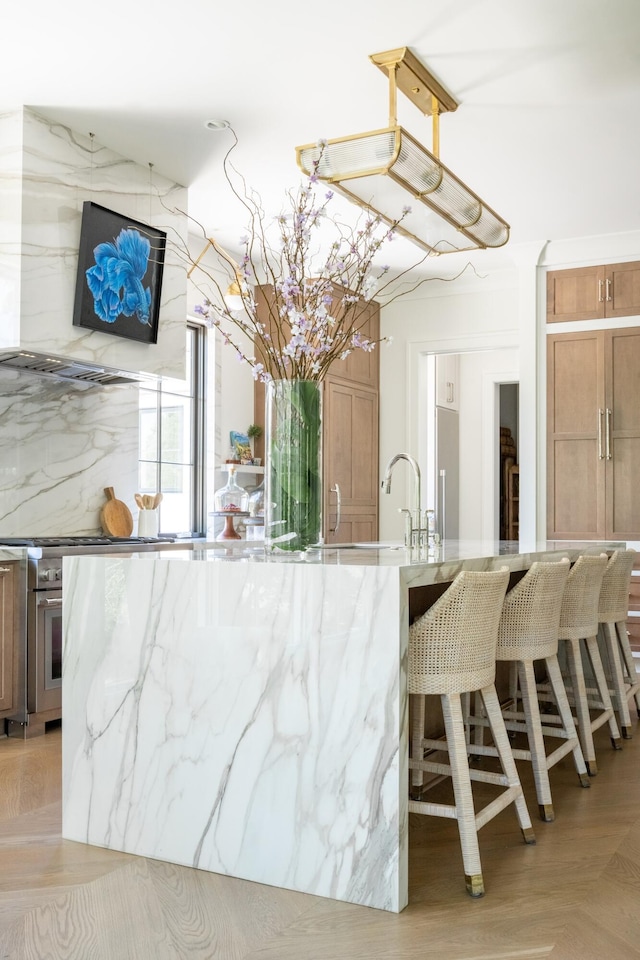 2538 Helmsman Rd, Johns Island, SC 29455 - kitchen with light stone countertops, wall oven, and a breakfast bar area