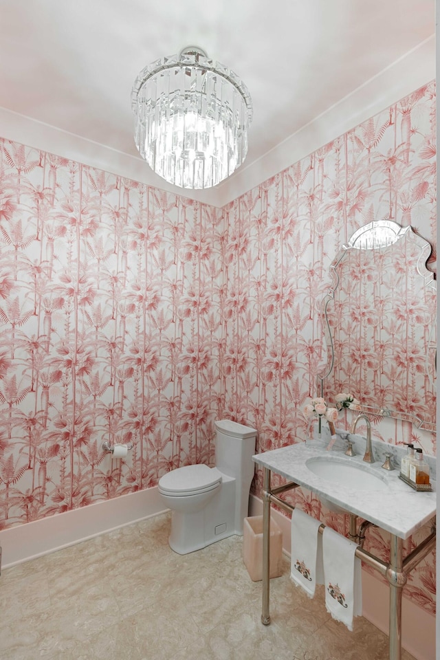 2538 Helmsman Rd, Johns Island, SC 29455 - bathroom featuring wallpapered walls, toilet, a chandelier, and a sink