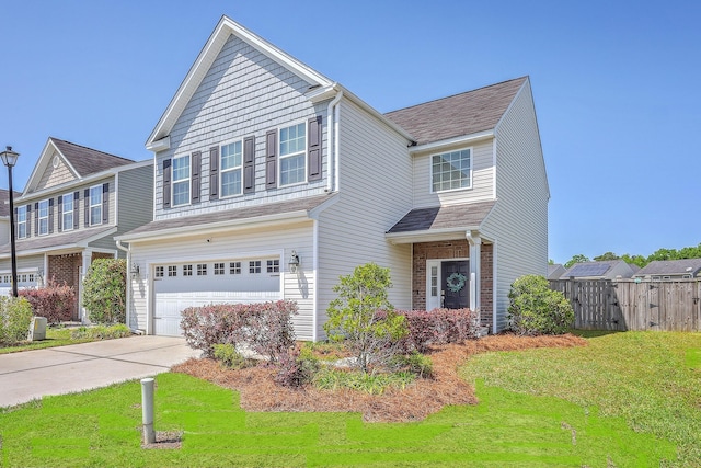 view of front of property with driveway, a garage, fence, and a front lawn