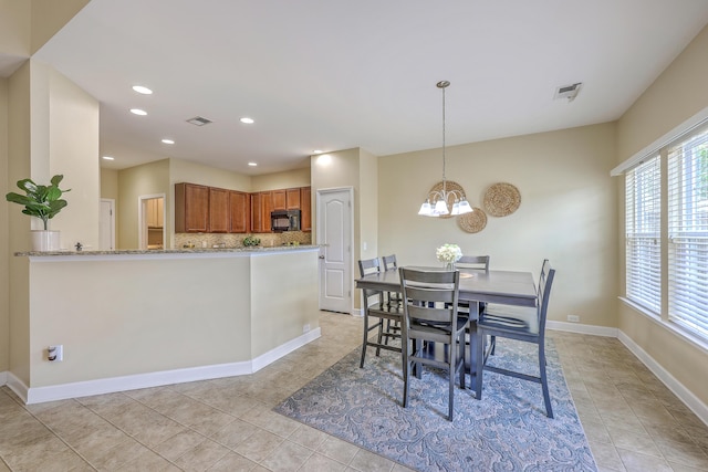 dining space featuring visible vents, baseboards, a chandelier, and light tile patterned floors