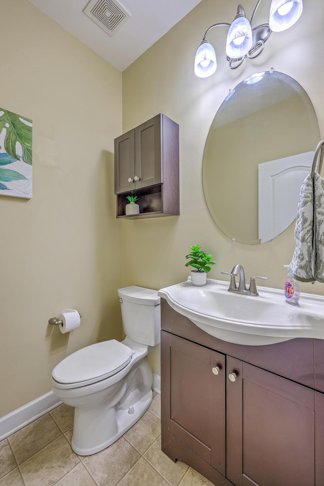 half bathroom with vanity, visible vents, baseboards, and toilet