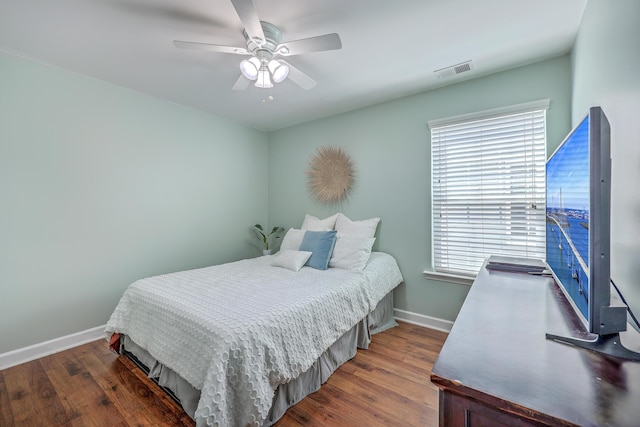 bedroom with dark wood-type flooring, visible vents, and baseboards