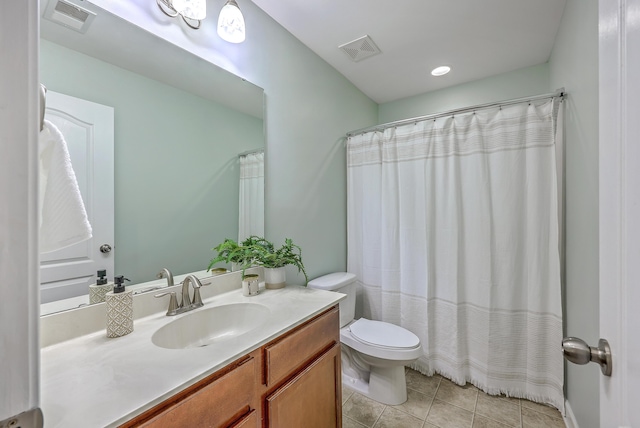 bathroom featuring toilet, vanity, tile patterned flooring, and visible vents