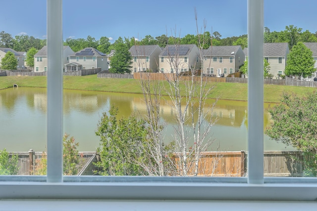 view of water feature with fence and a residential view