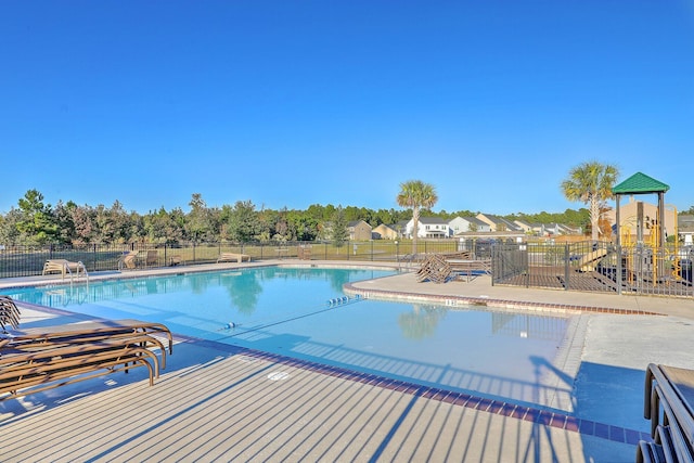 pool featuring fence and a patio