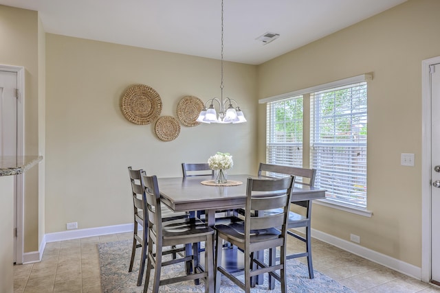 dining room with baseboards, light tile patterned flooring, a notable chandelier, and visible vents