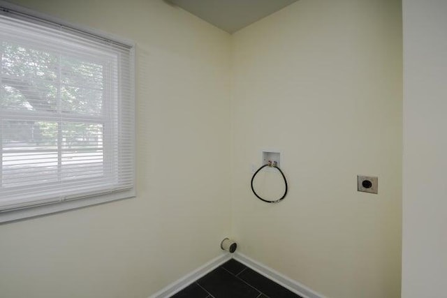 laundry room featuring washer hookup, hookup for an electric dryer, and dark tile patterned flooring