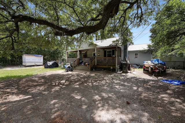 view of front of house featuring an outdoor structure and covered porch