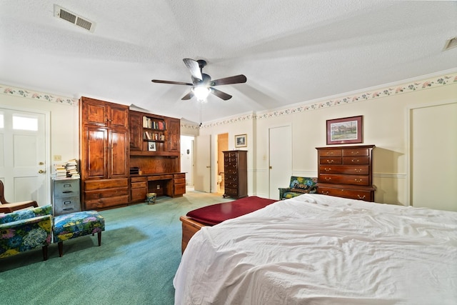 carpeted bedroom with ceiling fan and a textured ceiling