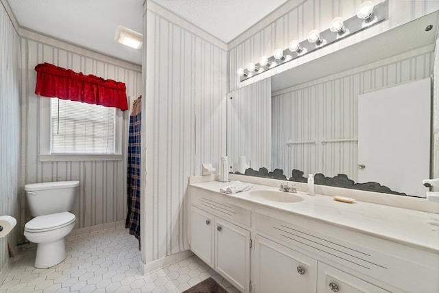 bathroom featuring tile patterned floors, vanity, and toilet