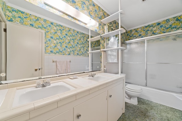 full bathroom with vanity, crown molding, toilet, and combined bath / shower with glass door