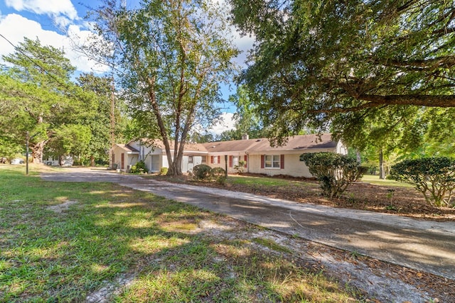 ranch-style house with a front lawn