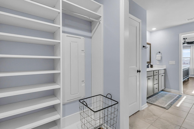 spacious closet featuring a sink, visible vents, and light tile patterned floors