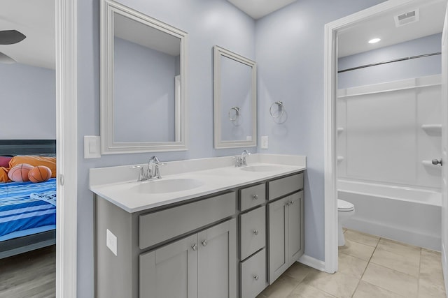 bathroom featuring a sink, visible vents, double vanity, and ensuite bathroom